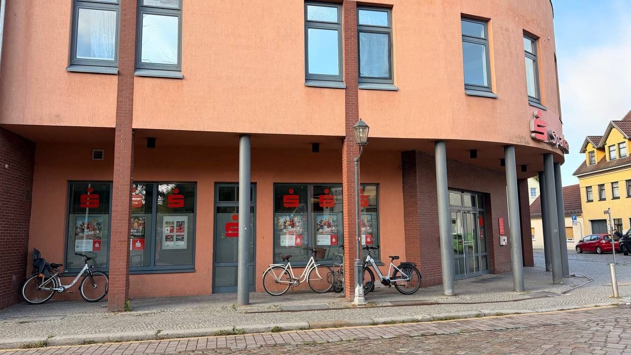 Sparkassengebäude mit Säulenarkade und gerundeter Ecke in Storkow